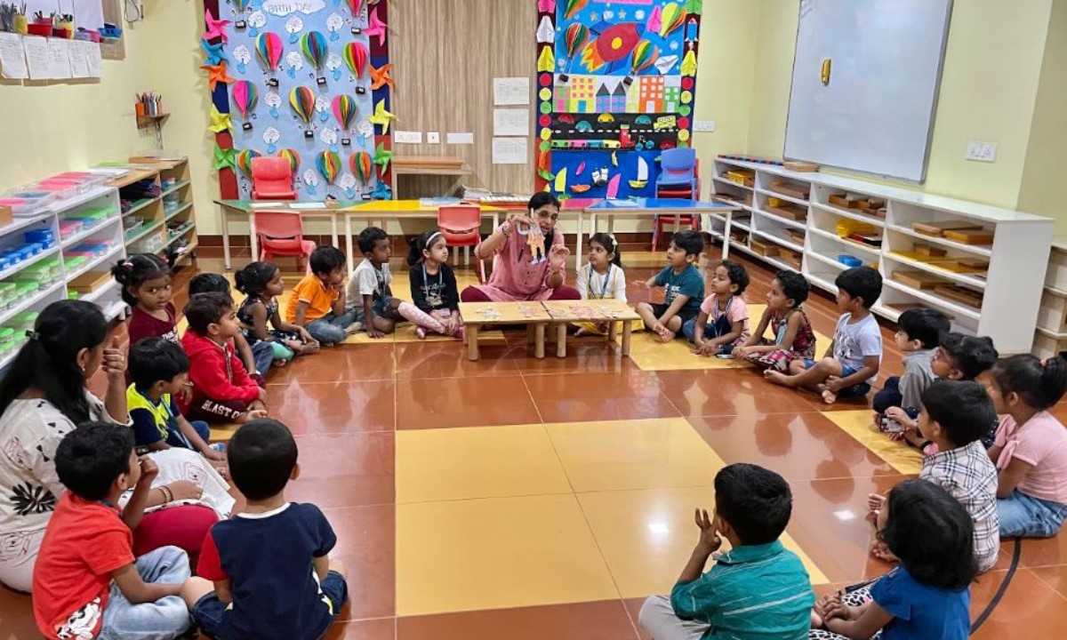 A teacher is explaining in the Montessori school at HSR Layout teacher explaining the kids