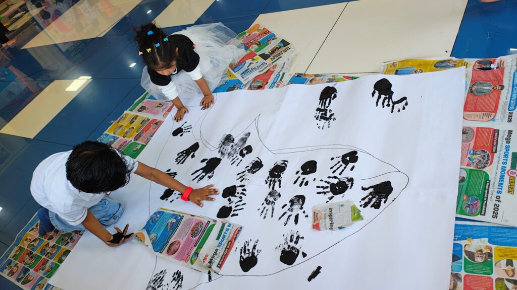 Children creating handprint art activity in a Montessori classroom