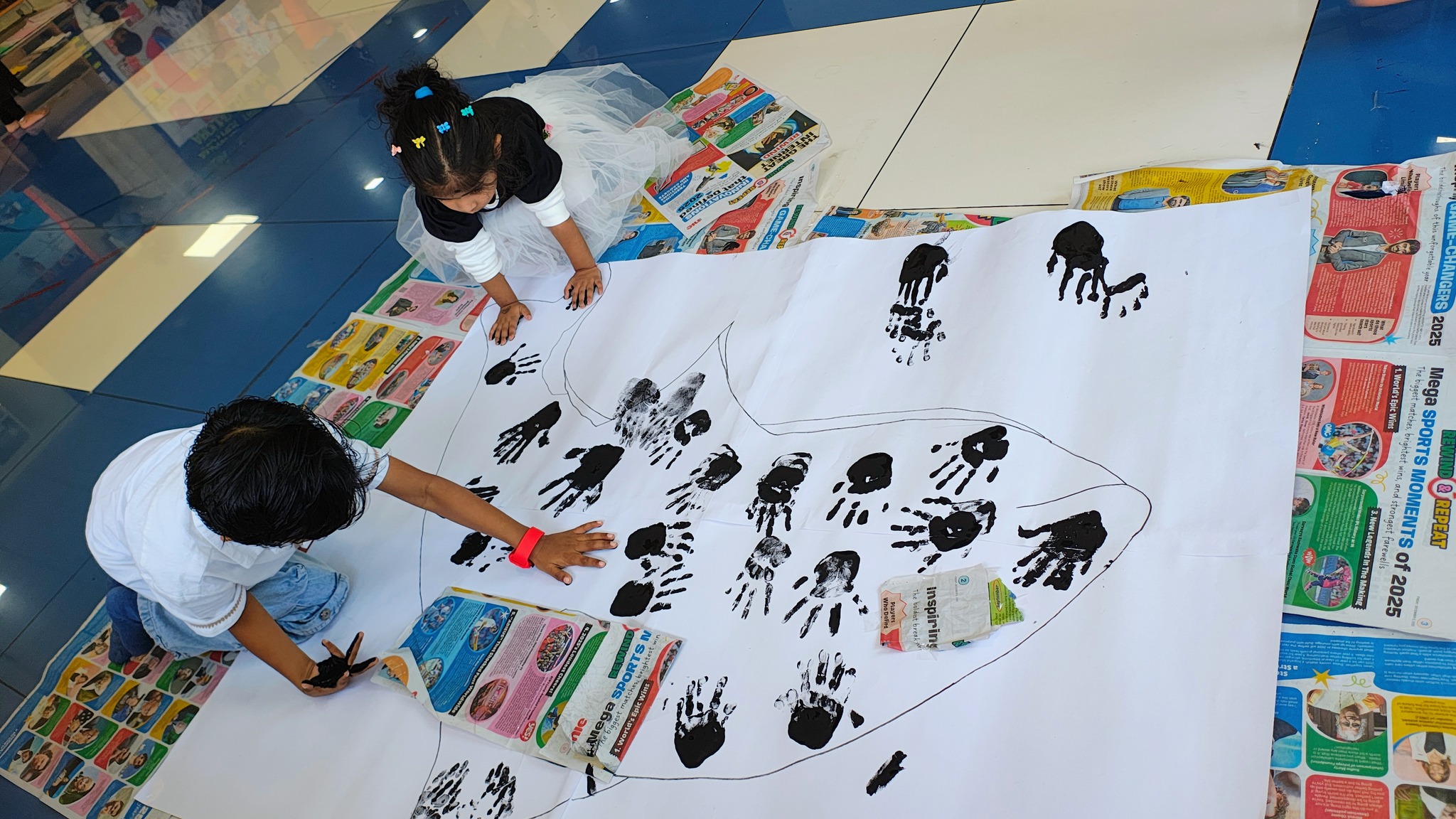 Children creating handprint art activity in a Montessori classroom