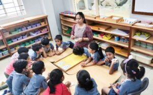 Montessori teacher guiding children in a classroom