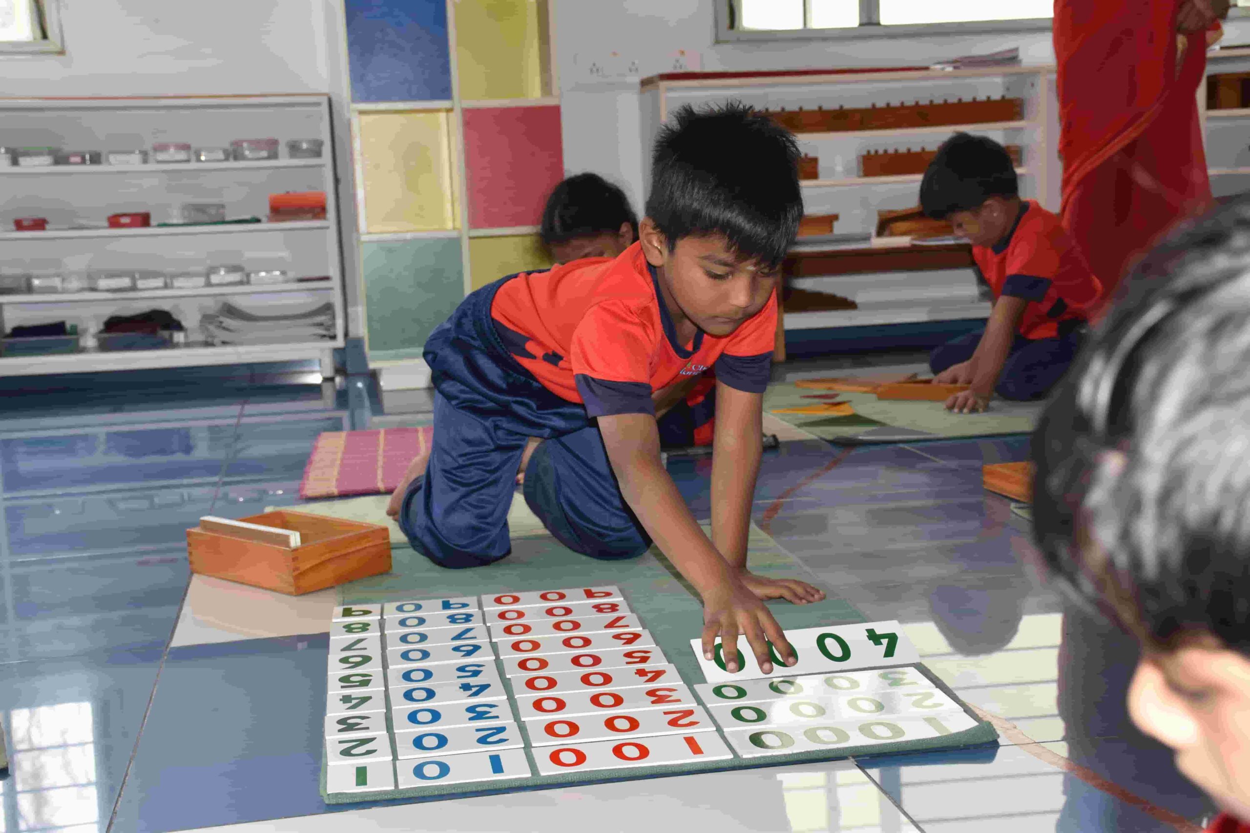 Child focusing on a hands-on learning activity in classroom