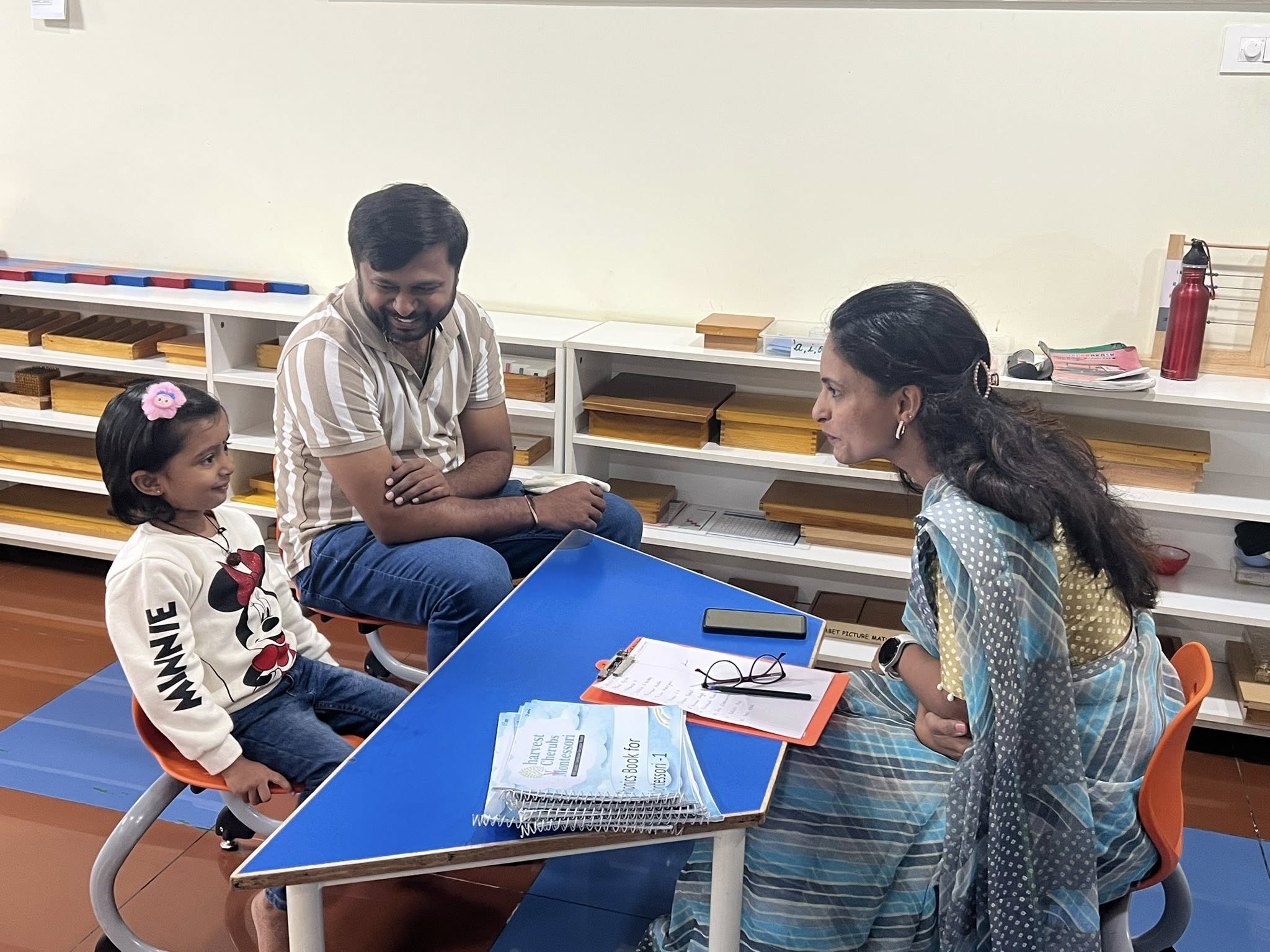 Parent teacher discussion about child progress in classroom