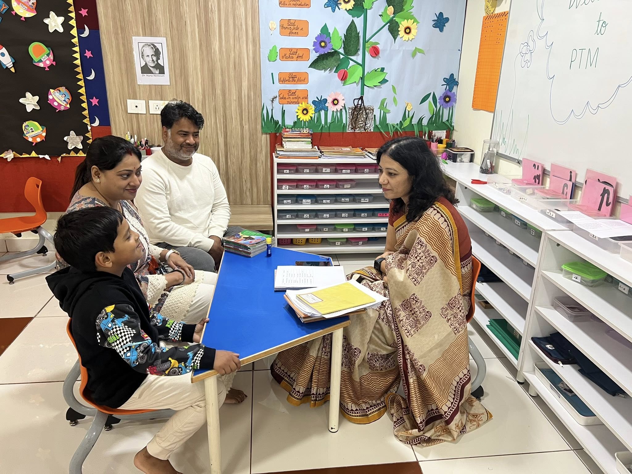 Parent teacher discussion about child progress in classroom